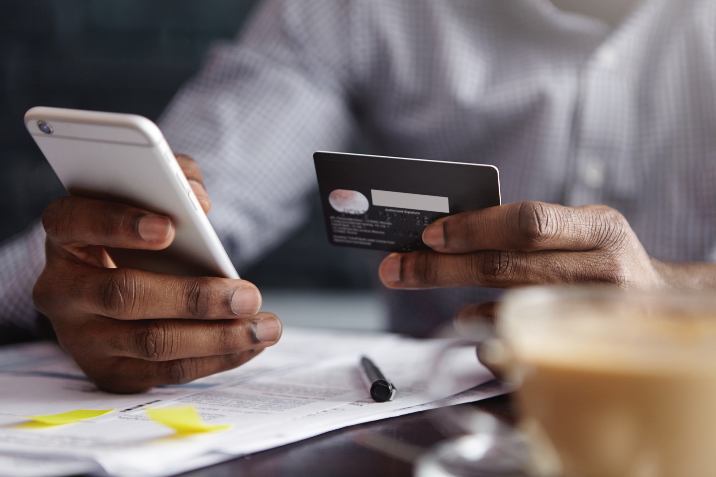 Man putting card details into his phone