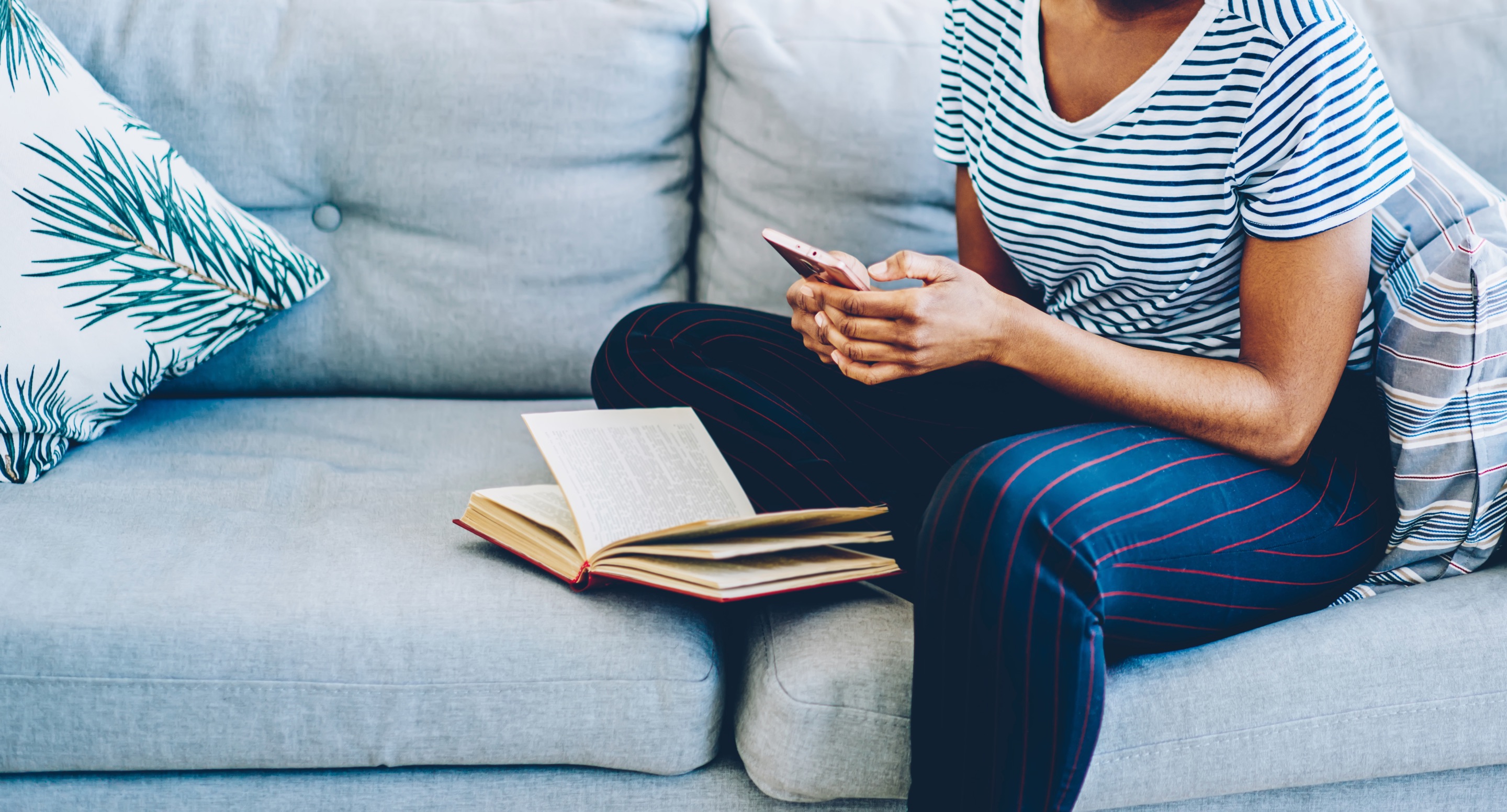 Woman on sofa reading her phone