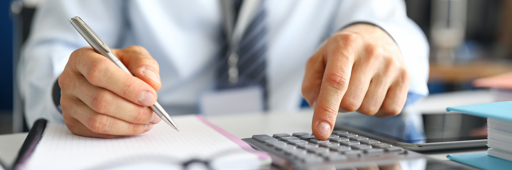 Man with calculator and pen