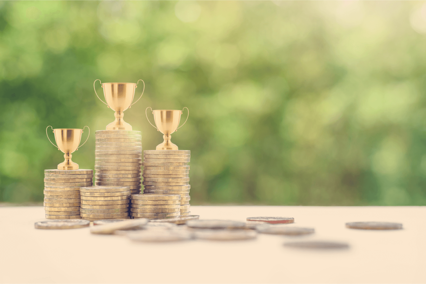 Stacks of coins with trophies on top