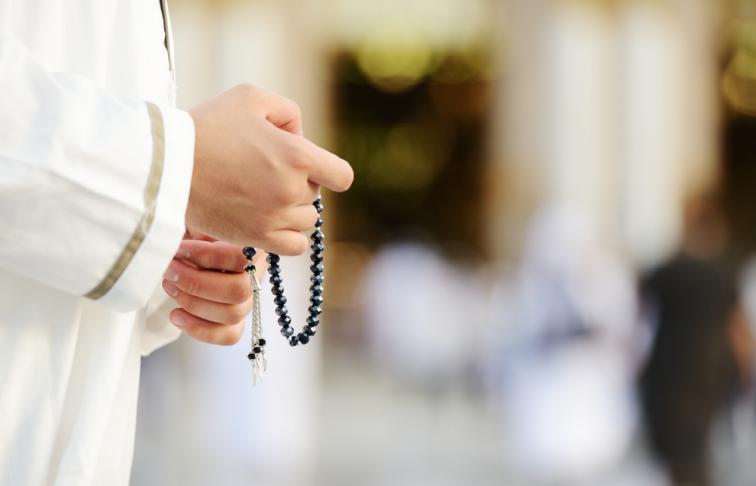 Hands with prayer beads