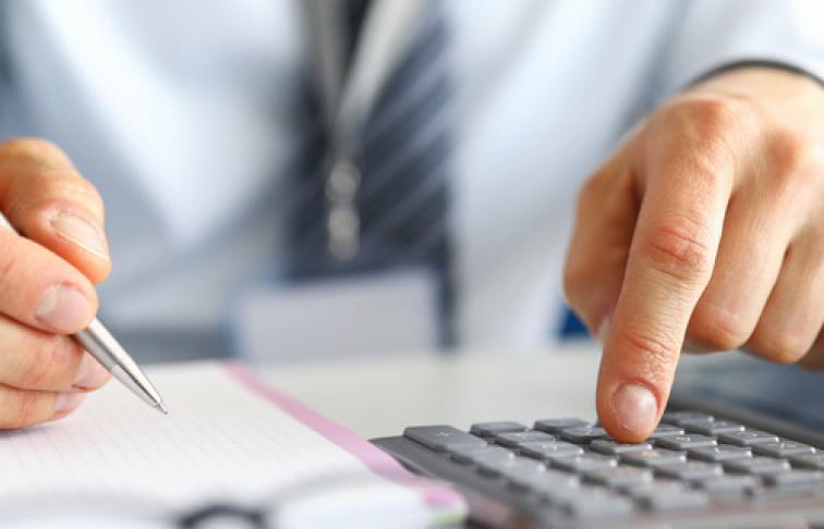 Man with calculator and pen