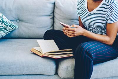 Woman on sofa reading her phone