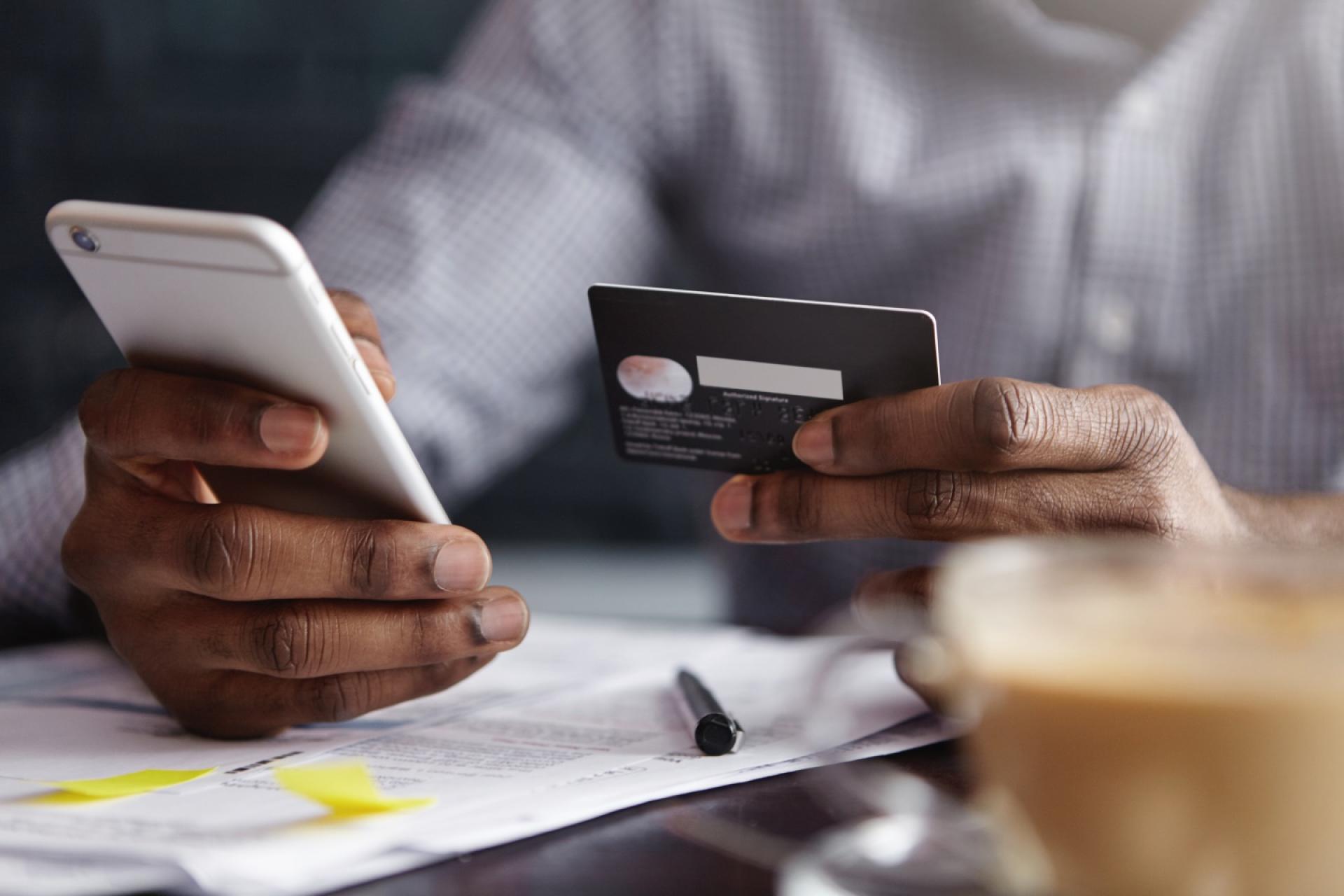Man putting card details into his phone
