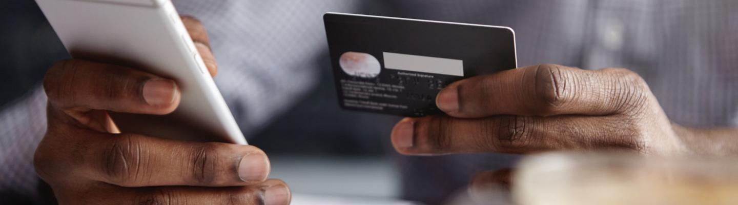 Man putting card details into his phone