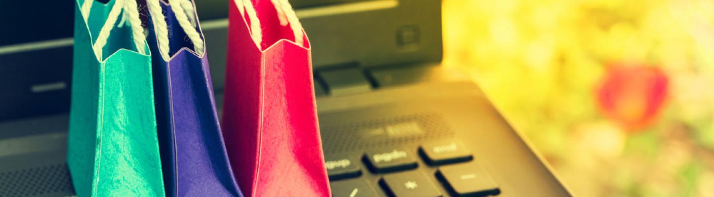 Shopping bags with computer keyboard, symbolising online shopping