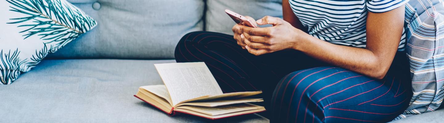 Woman on sofa reading her phone