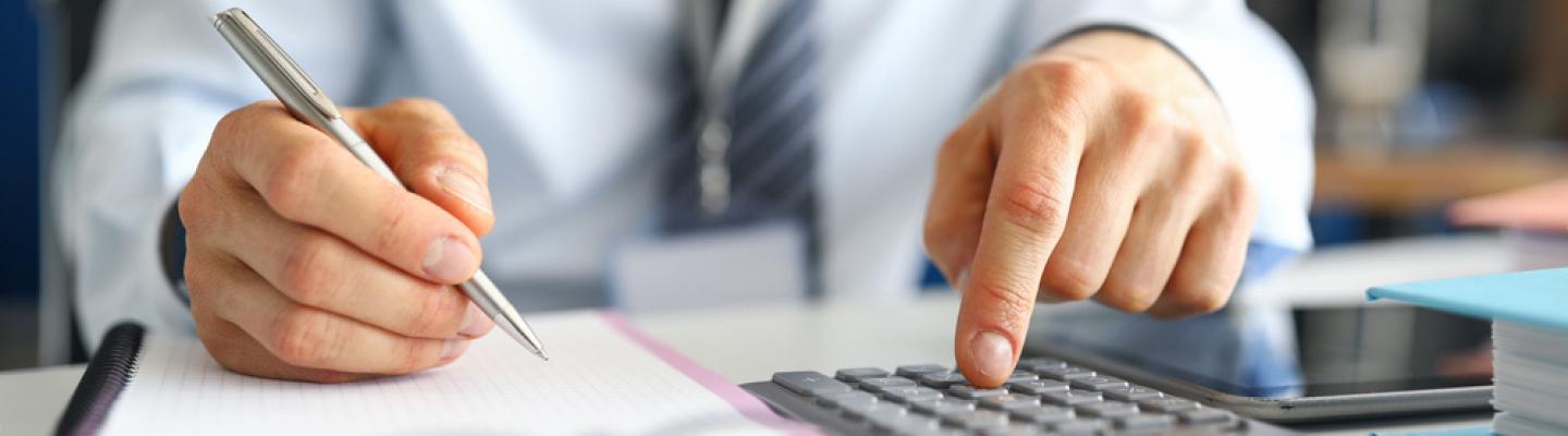 Man with calculator and pen