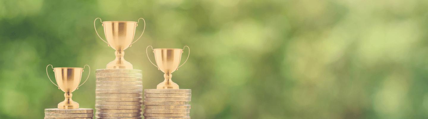 Stacks of coins with trophies on top