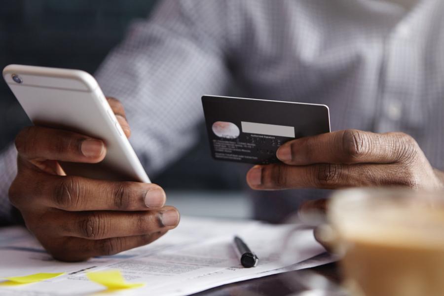 Man putting card details into his phone