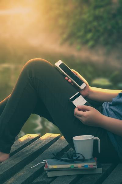 Woman banking through her mobile phone