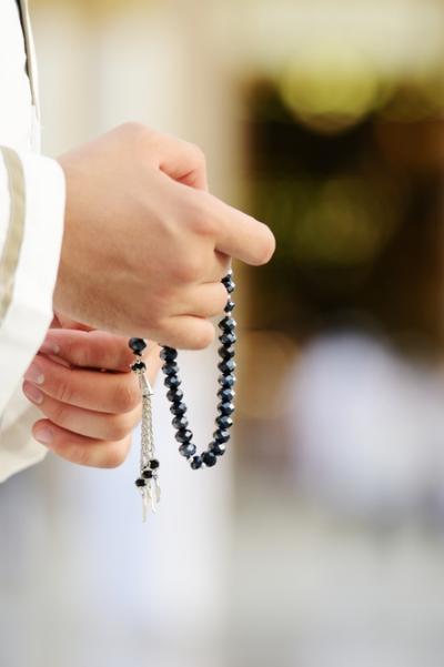 Hands with prayer beads